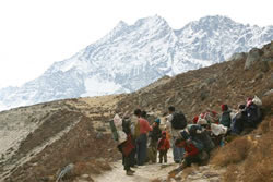 Tibetan refugees stop for rest, after crossing a mountain pass on the Nepal-Tibet border.