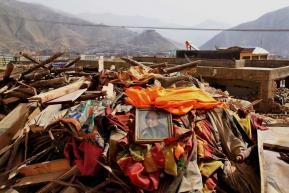 A photo of the Dalai Lama placed on top of ruins in Yushu.