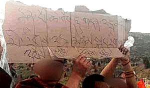 Monks holding a makeshift cardboard banner