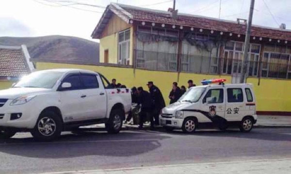 Police surround the body of a woman after she self-immolated.