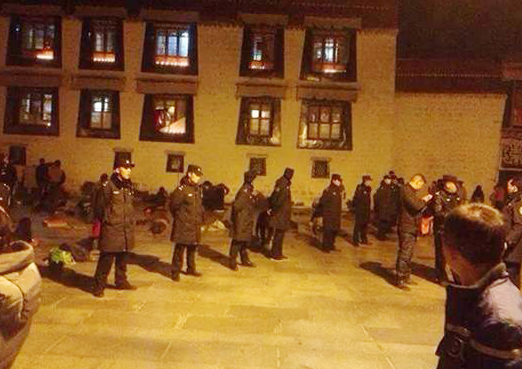 Police in black uniforms outside the Jokhang.