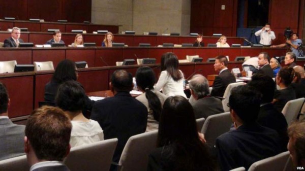A panel of Chinese, Tibetan, and Uyghur experts in front of CECC members during the hearing.