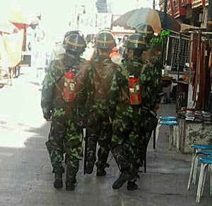 People's Armed Police carrying fire-extinguishers in Lhasa.